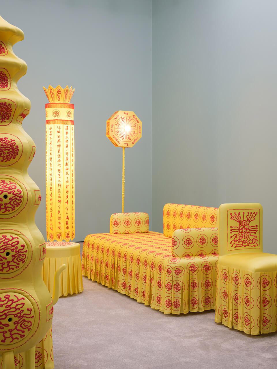 Close-up of yellow silk-covered furniture with red traditional Chinese patterns and decorative elements