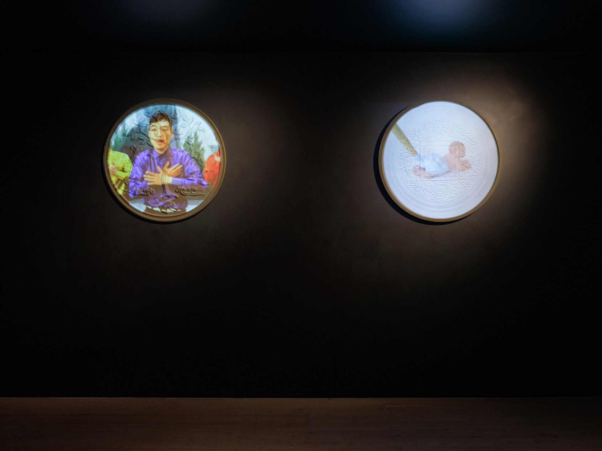 Video installation Jiu Bobo by Jiu Society with two circular digital screens displaying contrasting video content