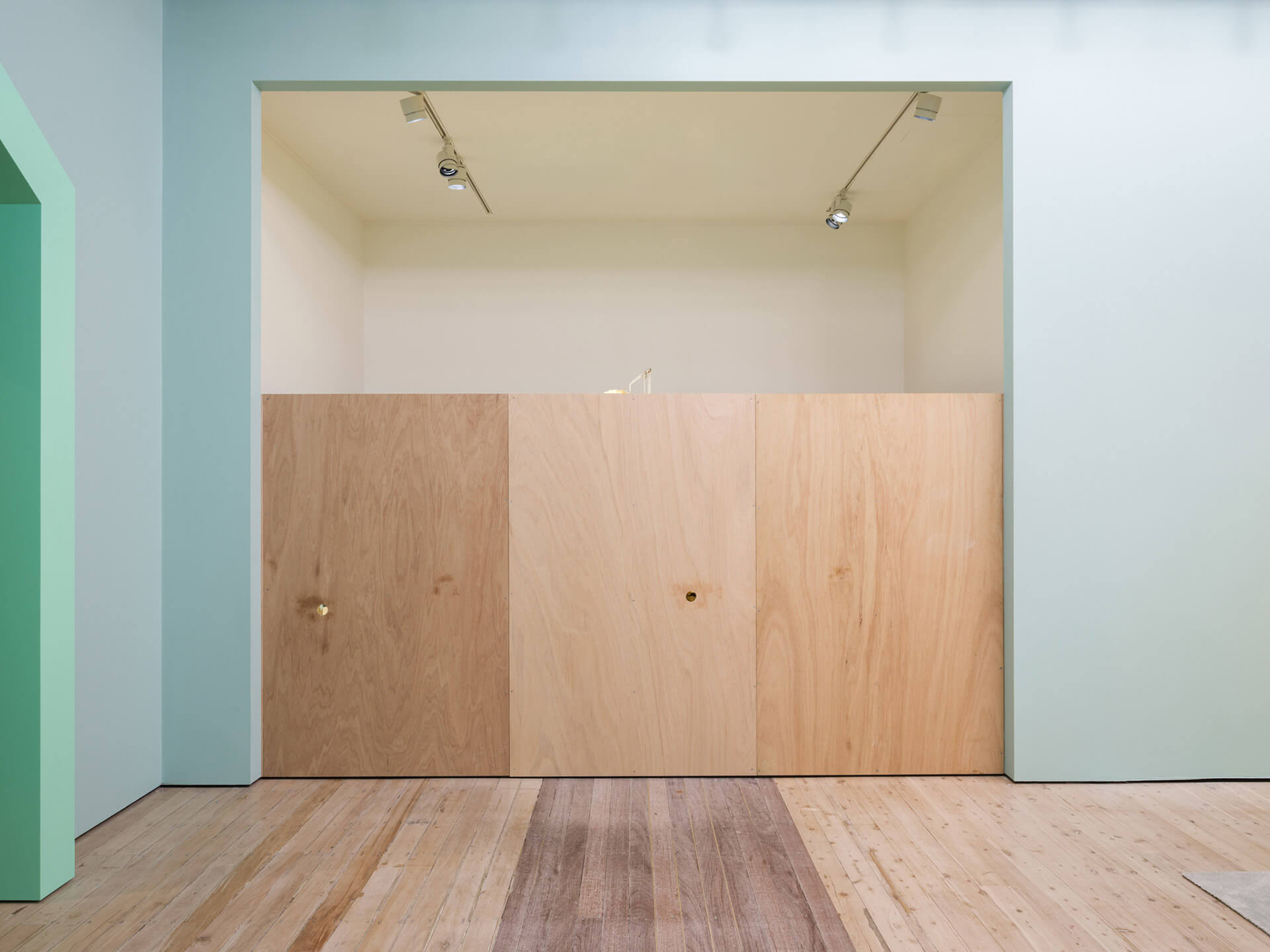 Clean minimalist gallery space displaying Shih-Yung-Chun's "Private Hotel 01" with pale green walls and wooden panels at White Rabbit Gallery