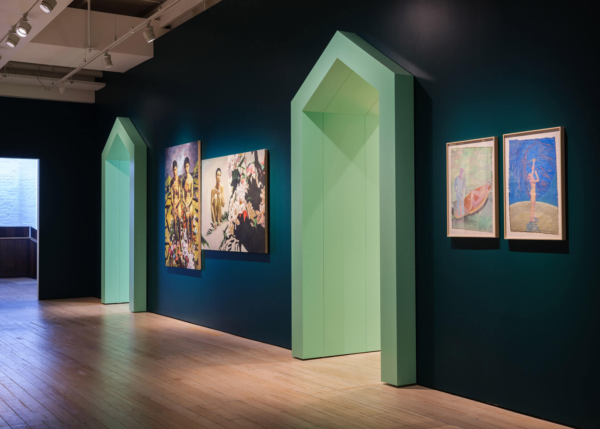 White Rabbit Gallery Level 2 corridor with white curtains and colorful flooring leading through Tender Comrade exhibition spaces