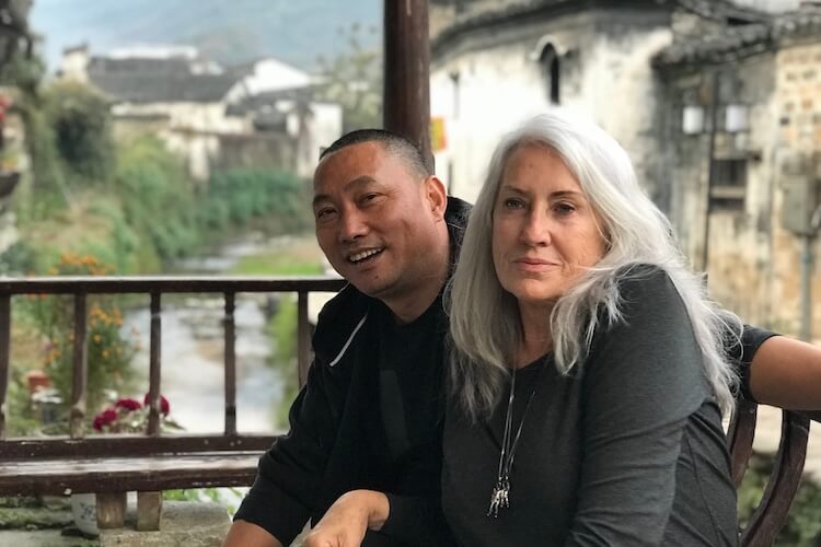 A male and female sitting in a building in rural China