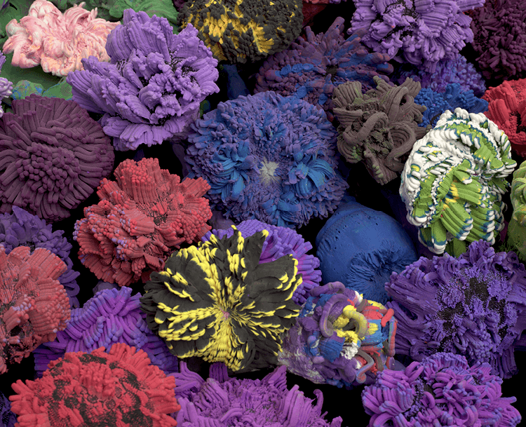 Bright, organic shaped lumps of paper clay and fabric, in purples, blue and red.