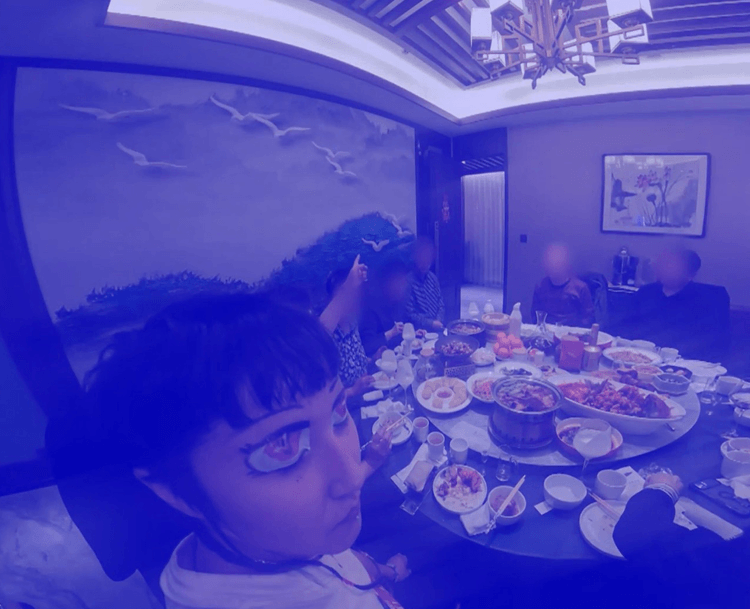 Footage with a purple tint of a group of people at Yum Cha