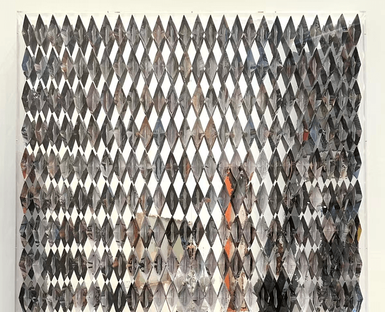 An installation of 364 folded paper boats and mirror film